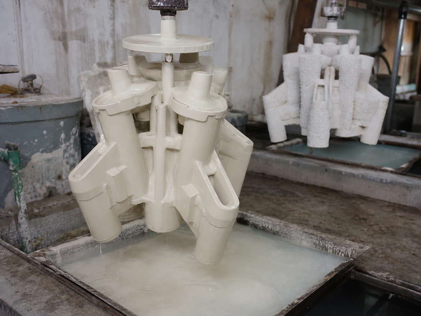 Ceramic slurry dipping and stucco coating of a wax tree